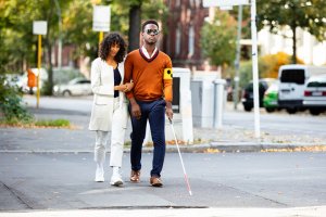 Young Woman and Blind Man On Street
